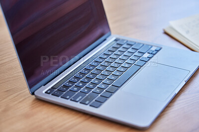 Buy stock photo Shot of a laptop on a desk in an empty office during the day