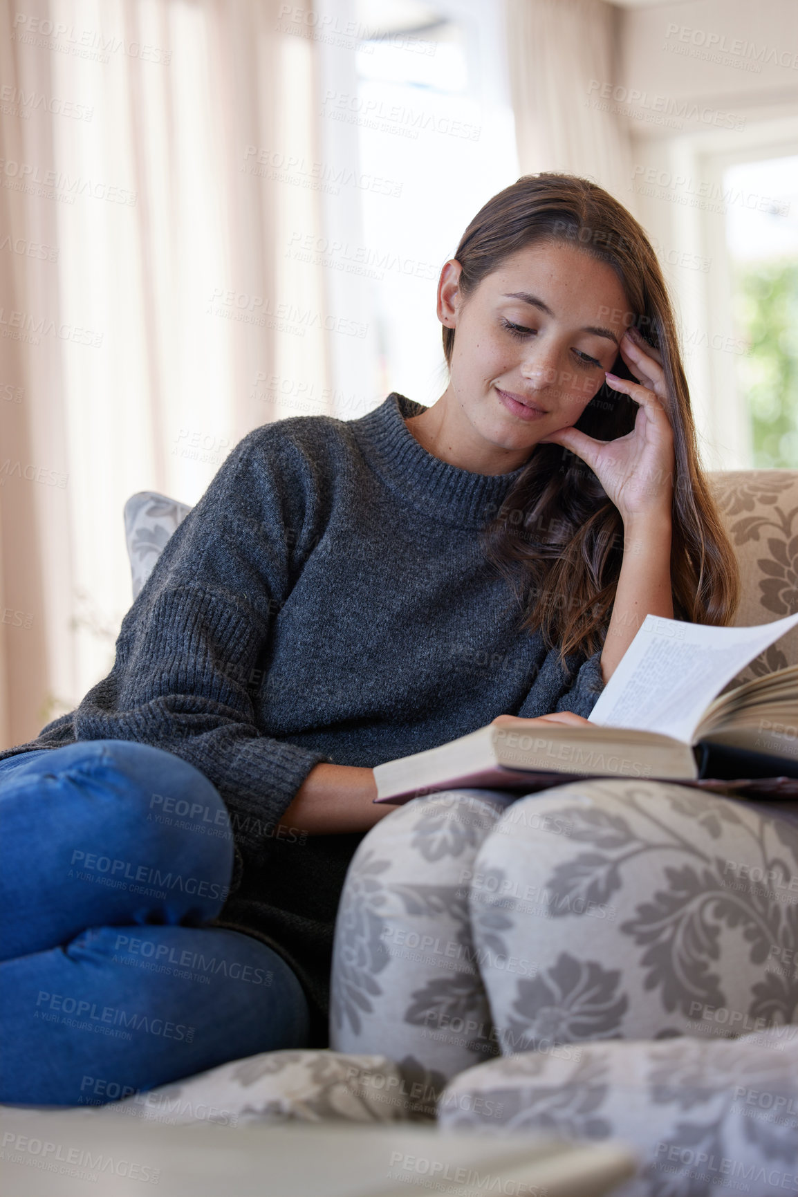 Buy stock photo Woman, book and reading on sofa in living room for relax, peace and knowledge in apartment. Female college student, learning and studying in home for creative writing, scholarship and university