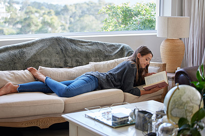Buy stock photo Woman, relax and book on sofa in living room for holiday, read and knowledge in home. Female university student, learning and studying for creative writing, scholarship and college assignment