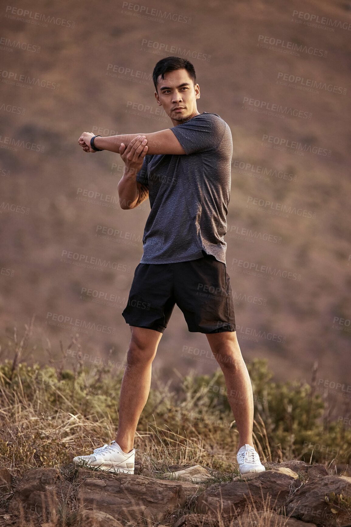 Buy stock photo Athlete, male person and fitness on mountain by stretching in outdoors for exercise, training and workout for health. Active and man in Mexico on path for muscles, wellness and calm in nature