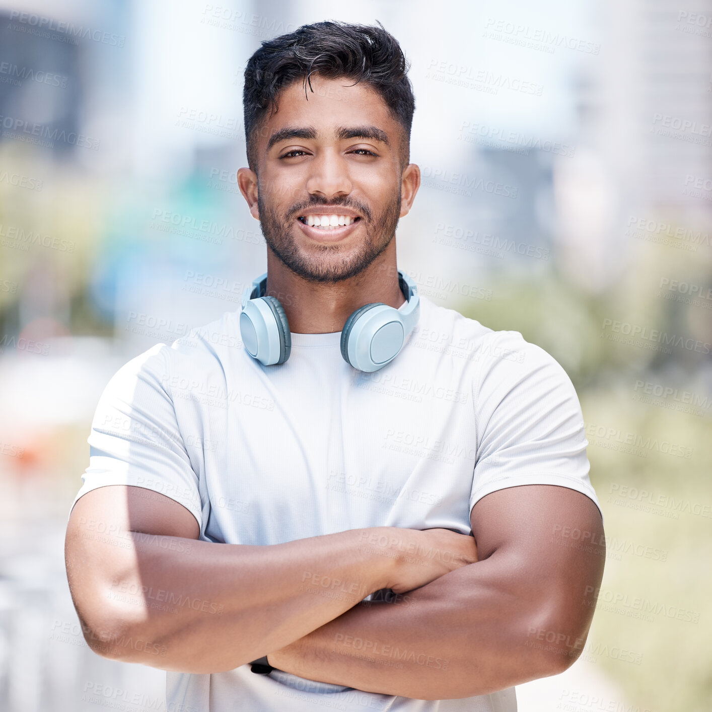 Buy stock photo Man, arms crossed in portrait and headphone outdoor for fitness, music or audio streaming with personal trainer in city. Confident, proud and athlete with wireless tech for radio, podcast or playlist