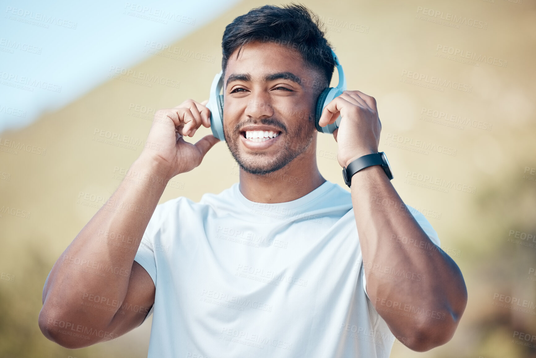 Buy stock photo Man, happy listening and headphones outdoor, music or audio streaming with personal trainer for fitness in city. Confident, smile and athlete with wireless tech for radio, podcast or playlist