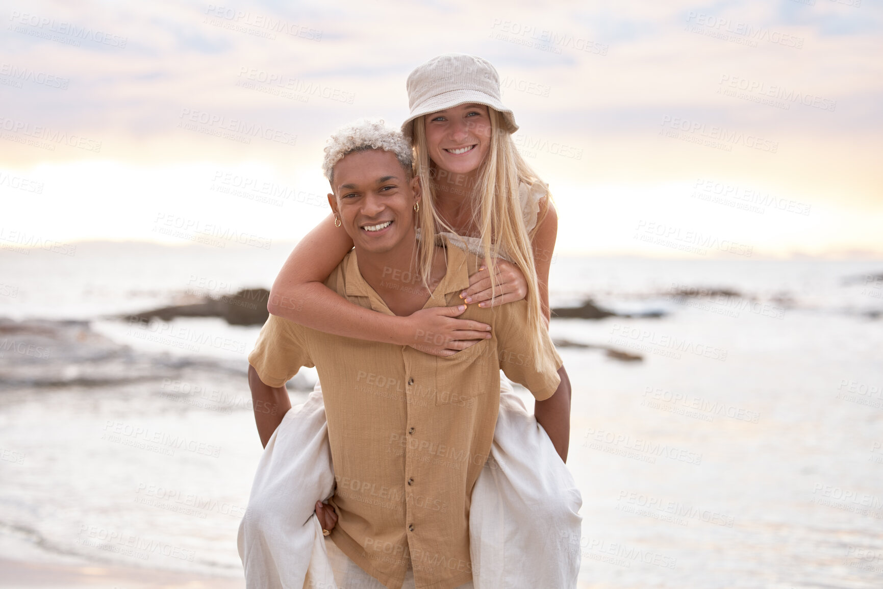 Buy stock photo Portrait, love or piggyback by happy couple at beach for fun, adventure or bonding at sunset together. Freedom, interracial relationship or people at sea with journey, romance or Mexico vacation date