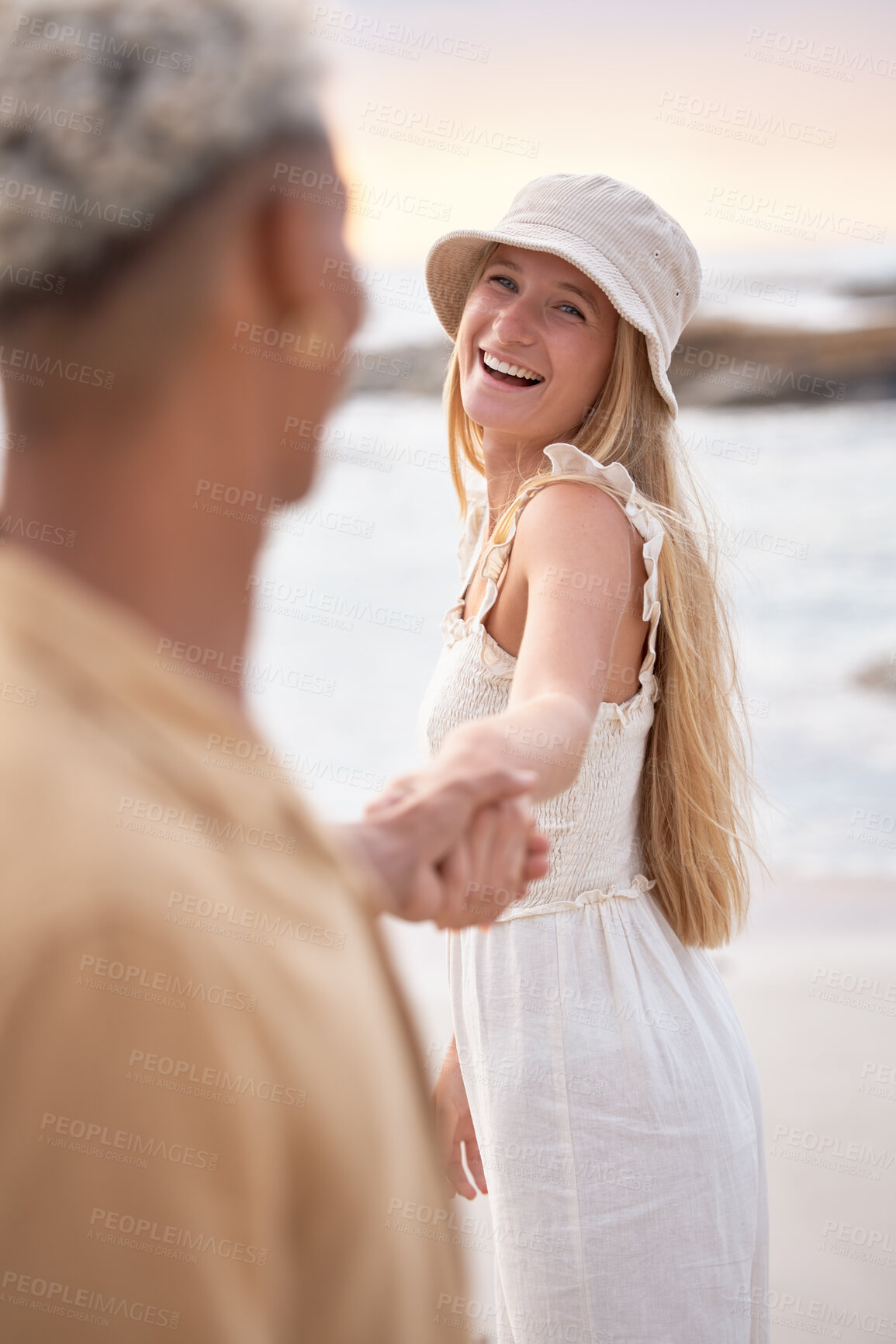 Buy stock photo Interracial, beach and couple holding hands, love and happiness with vacation, honeymoon and romance. Seaside, man and woman with joy, smile and marriage with weekend break, relationship and holiday