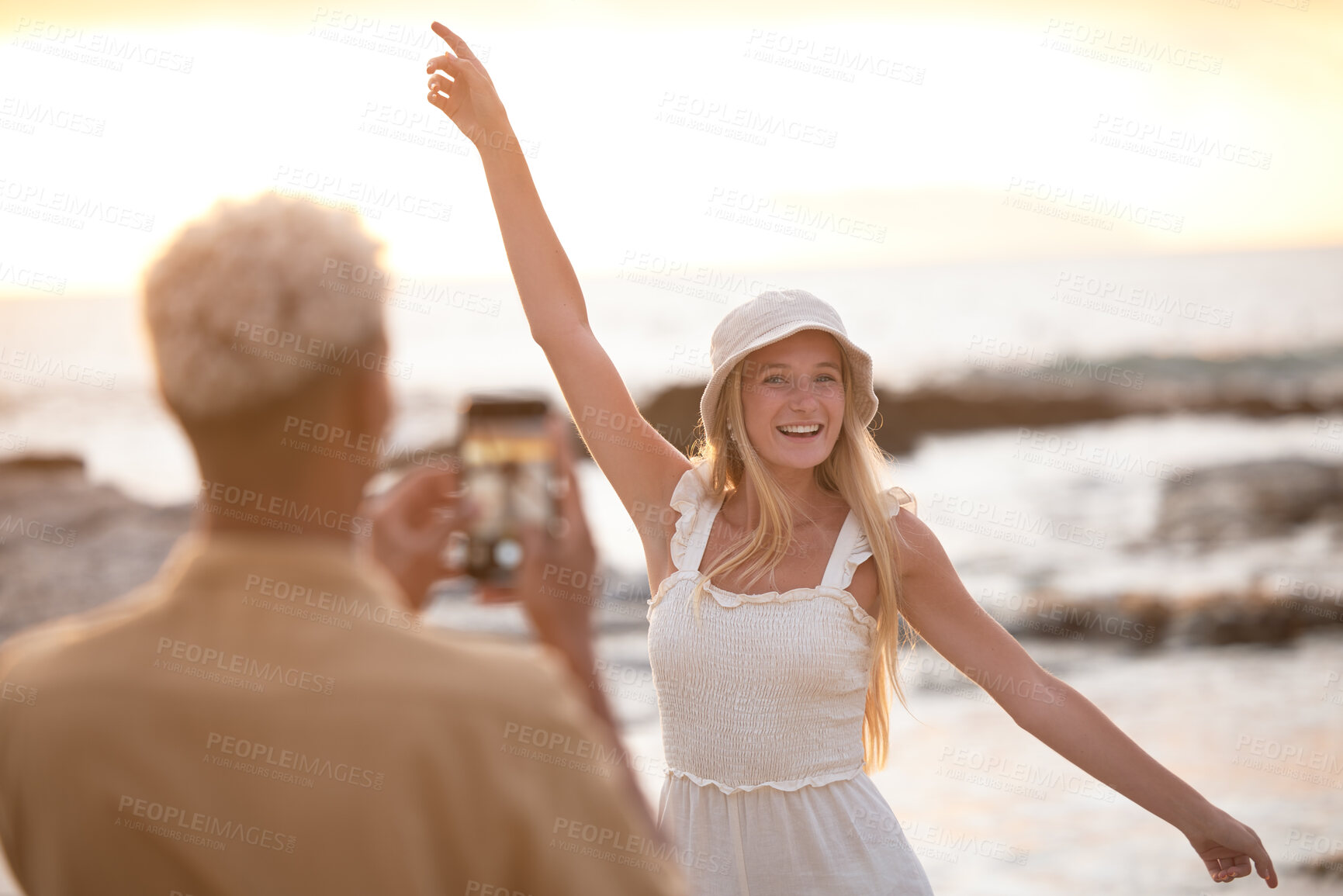 Buy stock photo Happy woman, photographer and beach with picture for memory, moment or outdoor model in sunset. Female person with smile in summer fashion for photography, capture or vlog by ocean coast in nature