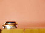 Stack of coins isolated against a brown background. Concept of money saving, investment, finance, currency and wealth. Costs increase with inflation in the economy. Budget your income for retirement