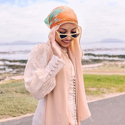 Buy stock photo Fashion, city and happy Muslim woman by sea with style, trendy clothes and casual outfit in Saudi Arabia. Religion, hijab and Islamic person with confidence, pride and sunglasses on summer weekend