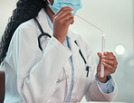 Hands of doctor holding covid test swab. Cropped gp holding a corona virus test swab and tube. Caring doctor holding a sample for a covid test. African american professional doctor holding test