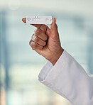 Hand of a doctor holding a negative covid test. African American doctor holding a corona virus test. Closeup of a caring doctor holding a covid test used in the pandemic.