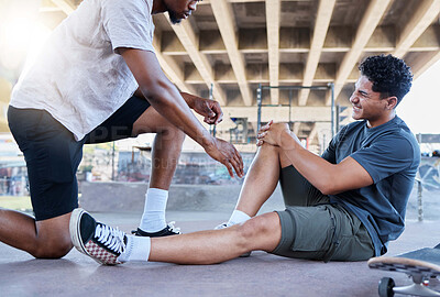 Buy stock photo Sports injury, knee and skater man holding wound after accident, falling and fail on skateboard at urban community skate park. Male friends, skating and helping with sore leg during training