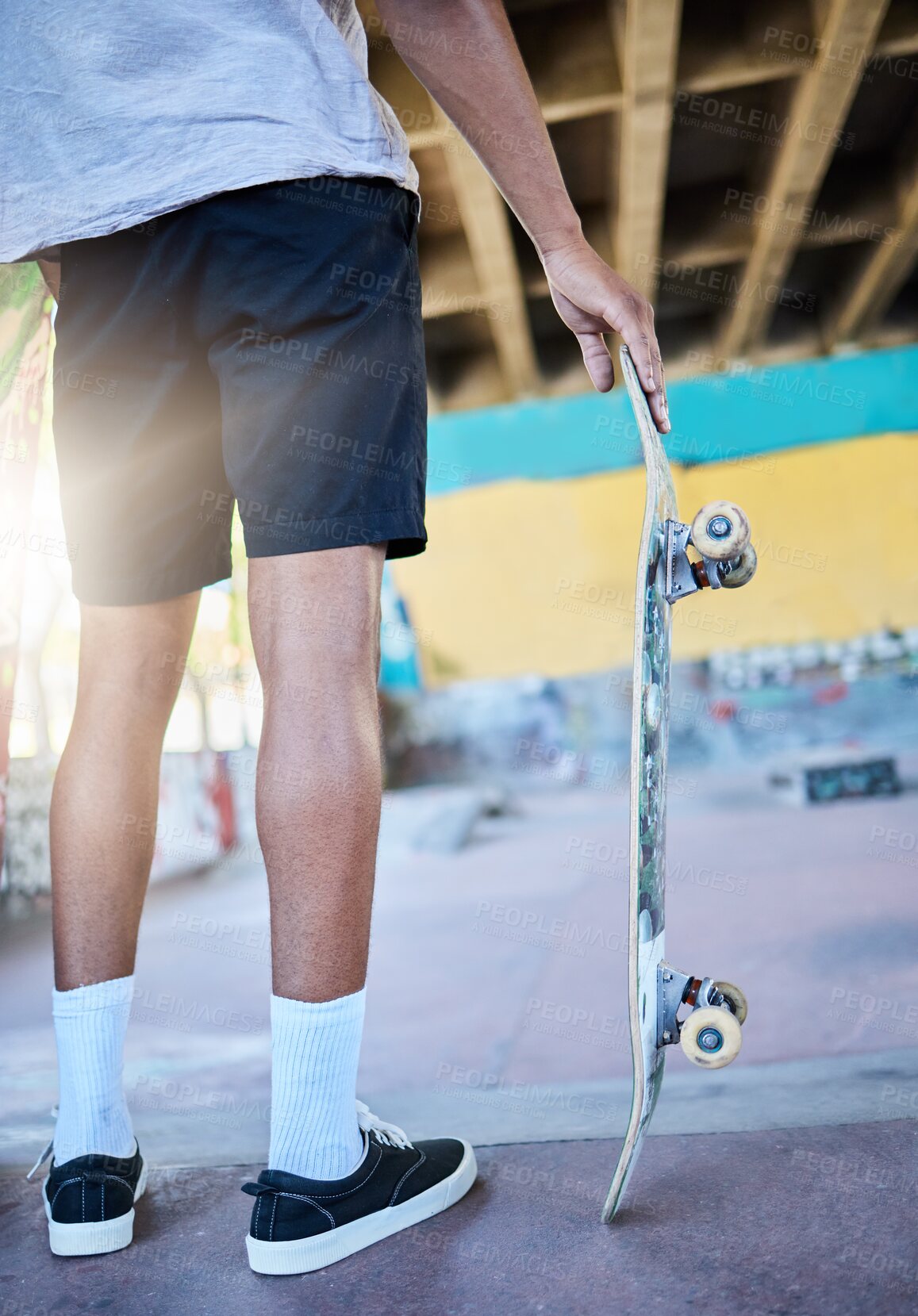 Buy stock photo Legs, skateboard and man at skate park, urban and skating for fun and fitness, trendy and active sport. Skater, sneakers and cool, ready to skate in the city with sunshine and hipster with off ramp.