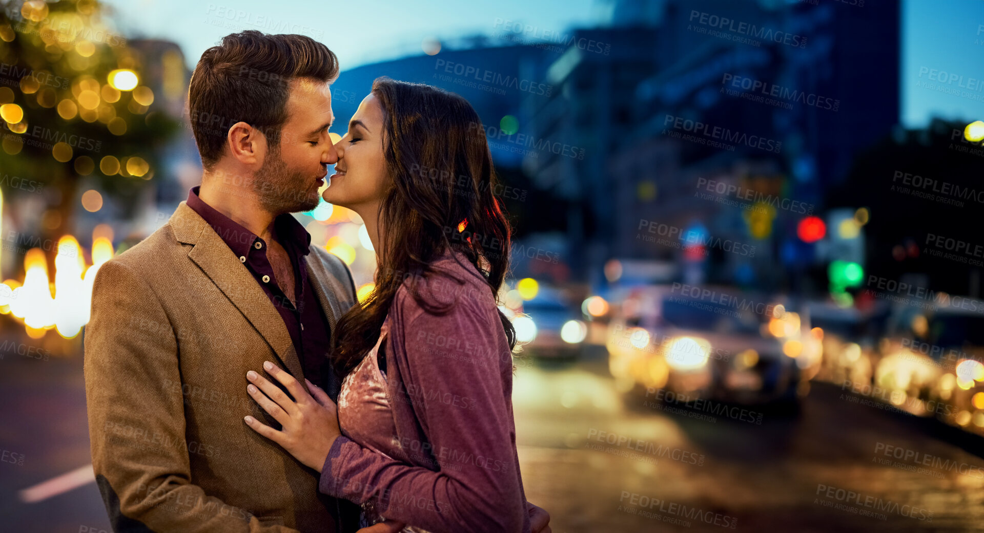 Buy stock photo Couple, night and kiss in city for love, nose touch and bonding for romance and sweet moment. Happy, affection and people in commitment and trust, security and support together with time together
