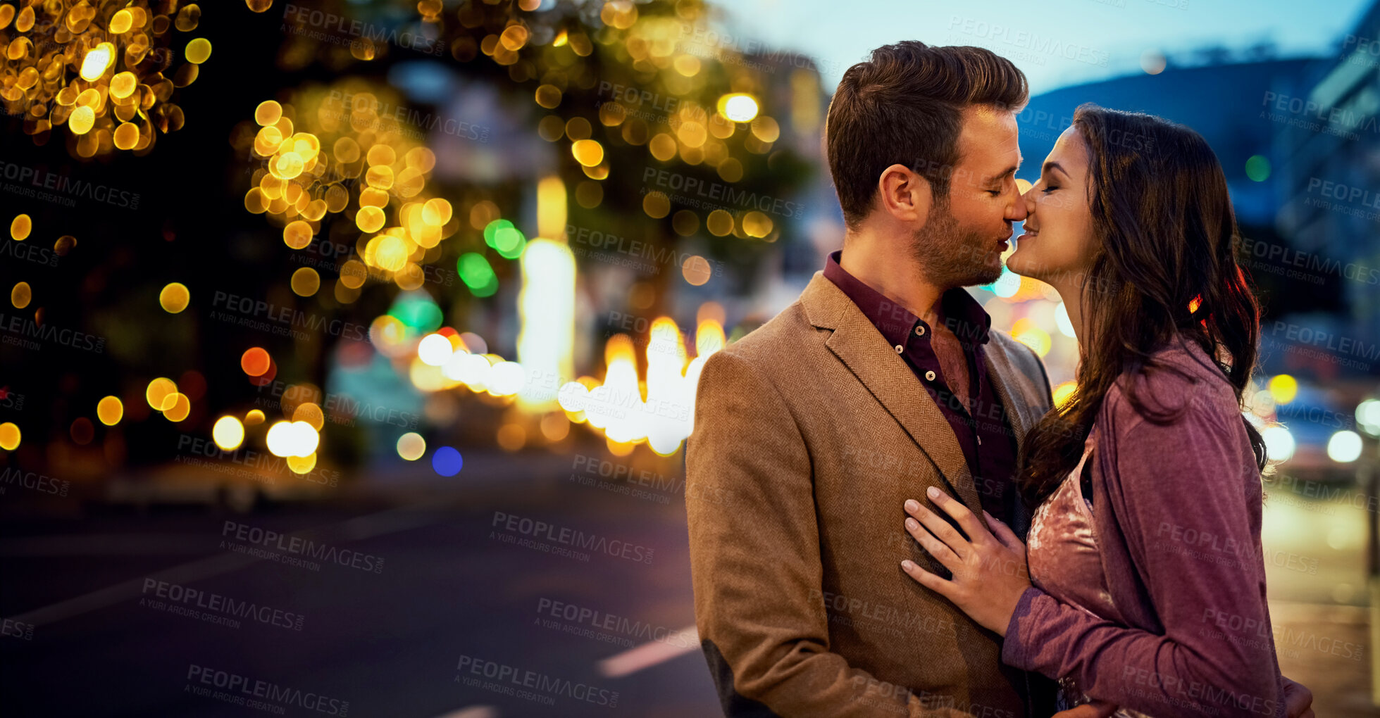 Buy stock photo Couple, night and kiss in city for love, nose touch and bonding for romance and sweet moment. Affection, happy people in commitment and trust, security and support together with time outdoor