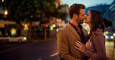 Buy stock photo Couple, night and city with hug and kiss on date, romance and bonding with love in relationship. Happiness, affection and people with commitment and trust, sweet moment and romantic together outdoor