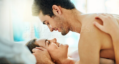 Buy stock photo Smile, love and couple in bed in home for romance, intimacy or bonding together in the morning. Happy man, woman and foreplay in bedroom, care and eye contact for connection in healthy relationship
