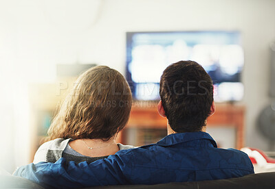 Buy stock photo Couple, relax and hug on sofa for movie or quality time on weekend, embrace and love with commitment. Man, woman and back view together in living room on couch for watching tv, streaming film or show