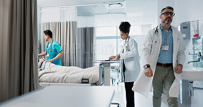 Buy stock photo Medicine, hospital and a healthcare team of doctors checking on a patient in recovery or rehabilitation. Medical, teamwork and consulting with a group of health professionals in a clinic for wellness