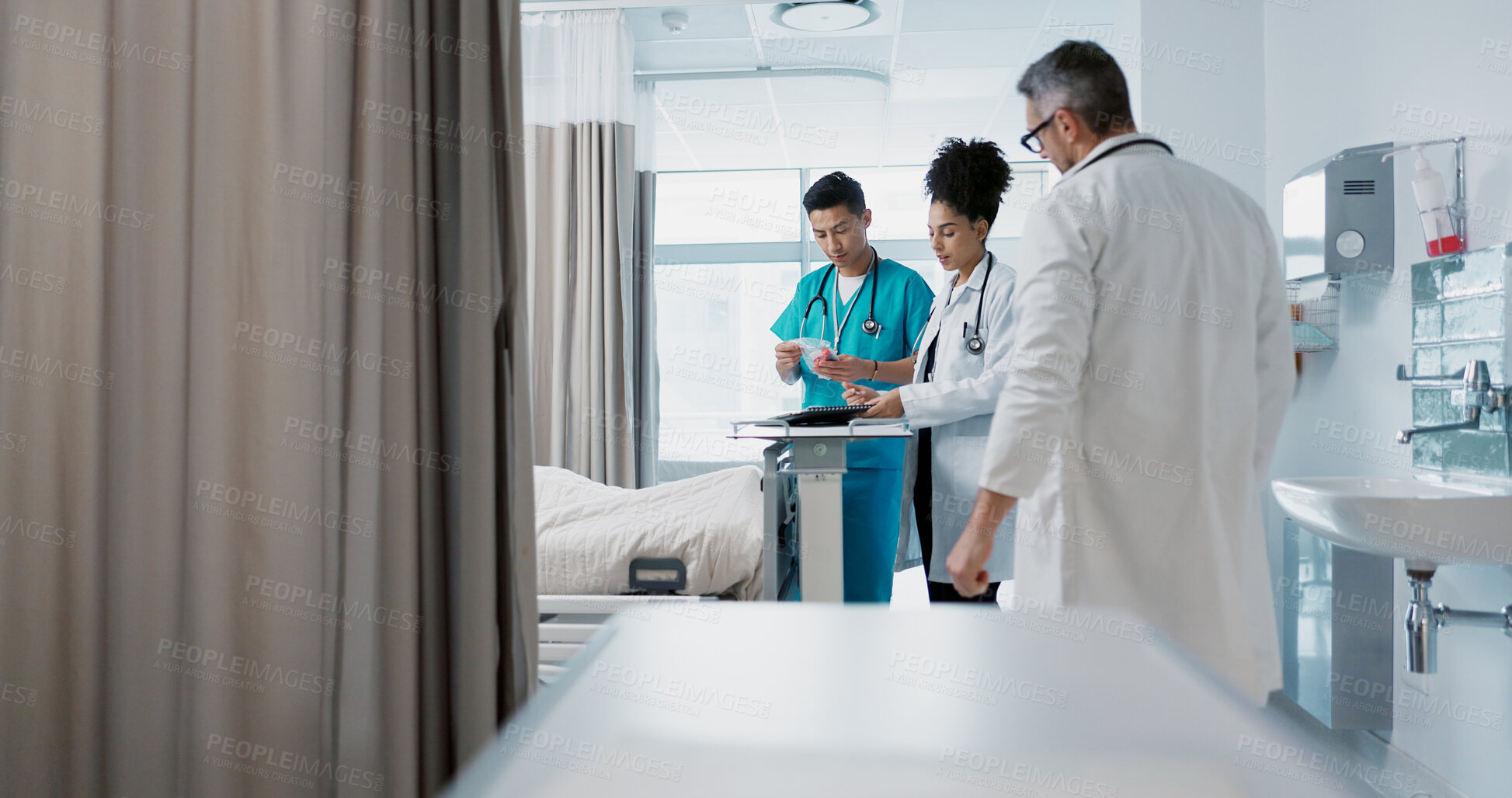 Buy stock photo Healthcare, hospital and a medical team of doctors checking on a patient in recovery or rehabilitation. Medicine, teamwork and consulting with a group of health professionals in a clinic for wellness