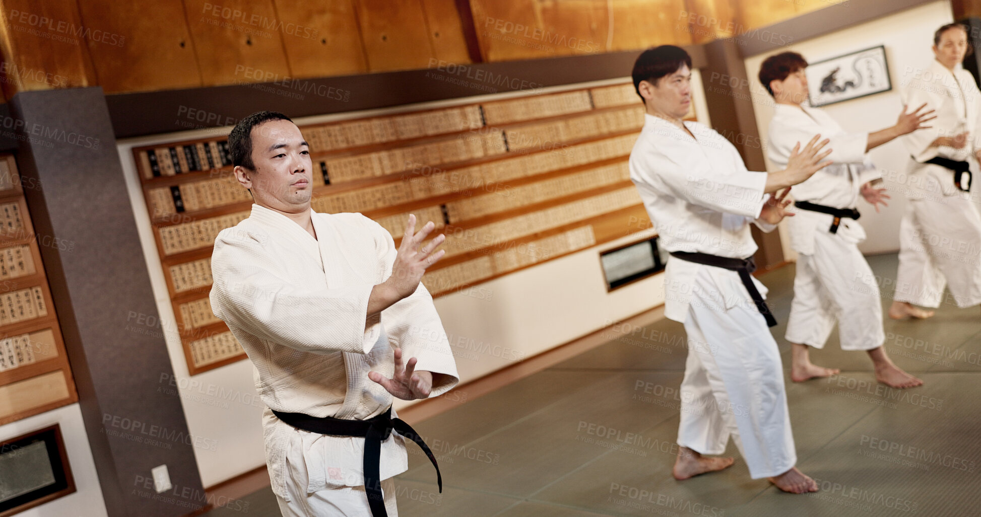 Buy stock photo Aikido dojo, students and fight for martial arts, strike or together for combat at training, gym or class. Japanese people, group and sport for exercise, workout or fitness with zen, conflict or club