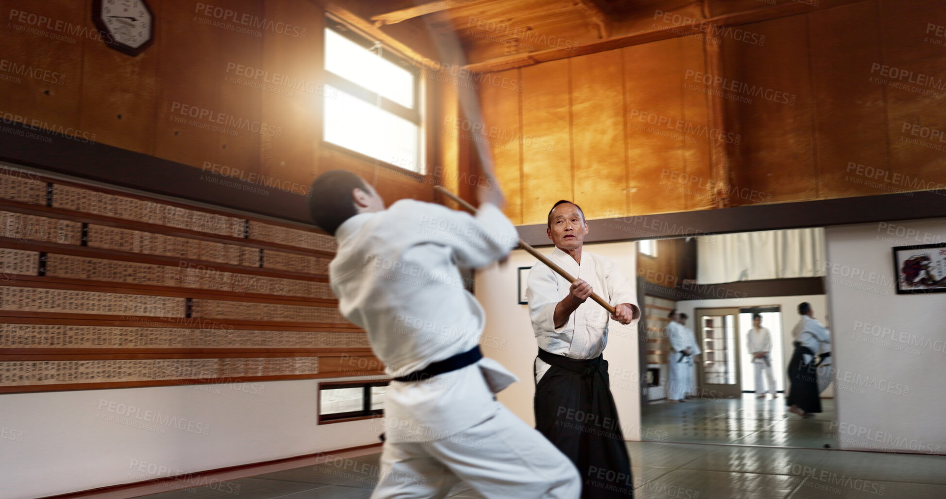 Buy stock photo Aikido men, fight and bokken for martial arts, weapon or contest for black belt students at training, gym or dojo. Japanese people, wood sword and sensei for exercise, workout and fitness in battle