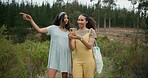 Happy woman, friends and phone in forest for social media, photography or pointing for natural outdoor scenery. Female person or people smile with mobile smartphone in nature or woods with trees