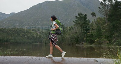 Nature, backpack and young woman hiking in forest on vacation, adventure or weekend trip. Travel, walking and female person trekking for fun in outdoor woods with bag for exploring on holiday.