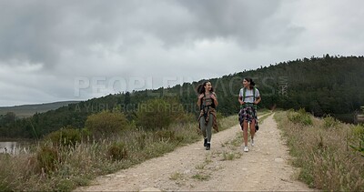 Friends, women in park and hiking in nature, walking and travel together with fun outdoor. Adventure, journey and fitness, sightseeing for tourism in environment and backpacking with trekking