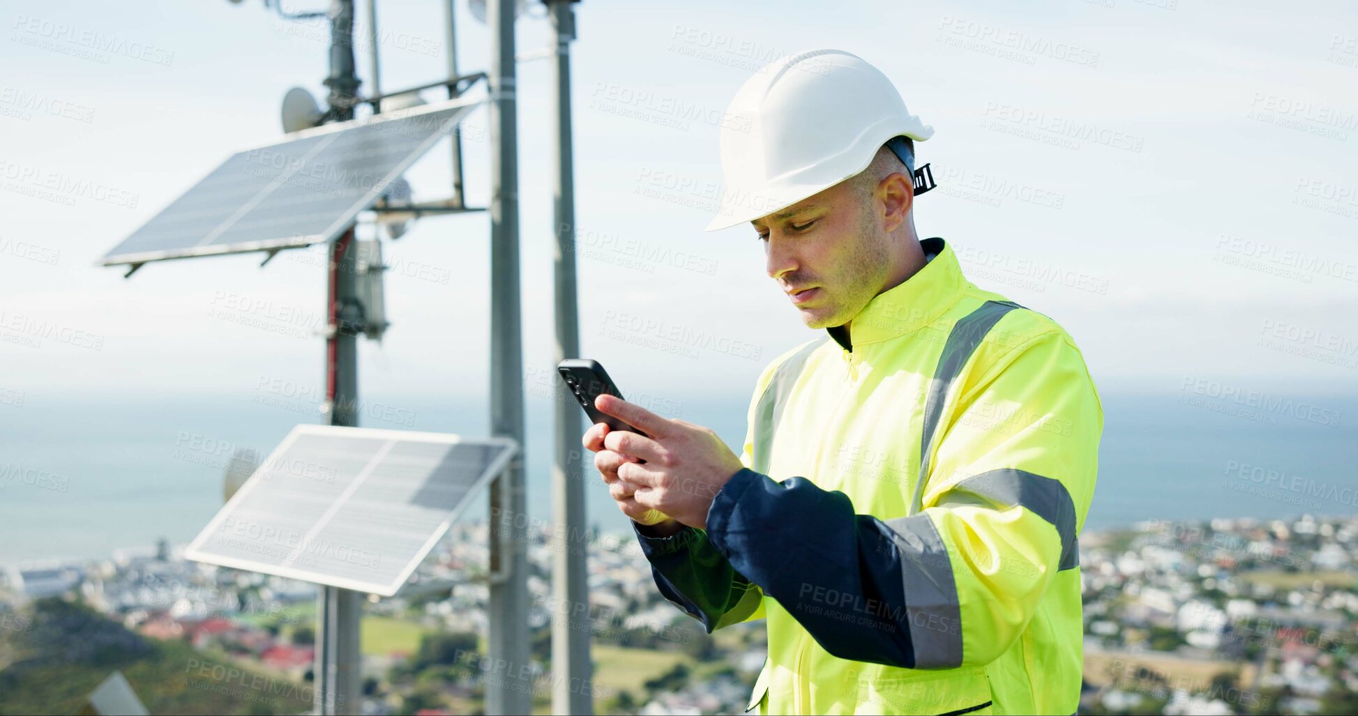 Buy stock photo Man, phone and engineer for social media, research or alternative energy and maintenance or inspection on rooftop. Person, contractor or technician on mobile smartphone for communication in city