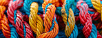 Knot, color and pattern of rope with connection, bundle and texture for craft, safety or strong network. String, thread or yarn on wallpaper with abstract textile, creative lines or rainbow diversity