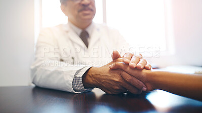 Buy stock photo Shot of a mature doctor holding a patient's hand in comfort