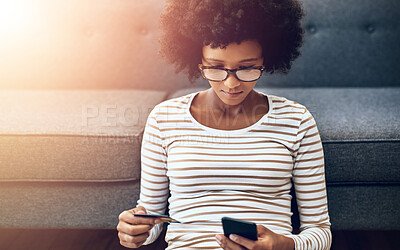 Buy stock photo Black woman, phone and credit card for ecommerce, payment or purchase in living room at home. African female person or shopper sitting on floor with smartphone or debit for online shopping or banking