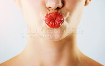 Buy stock photo Cropped studio shot of a beautiful young woman wearing red lipstick and pouting against a gray background