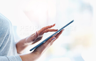 Buy stock photo Closeup shot of an unidentifiable businesswoman using a digital tablet in an office
