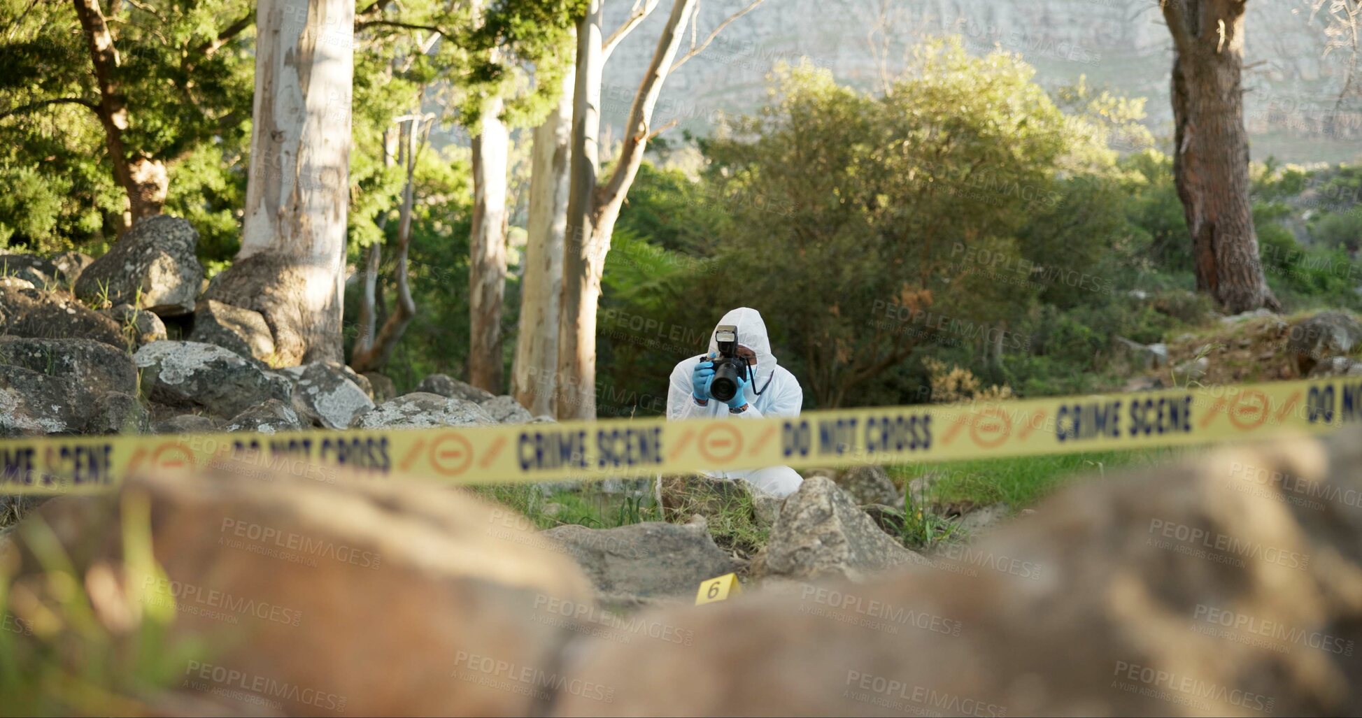 Buy stock photo Csi, photographer and evidence at crime scene for investigation in forest with police tape and safety hazmat. Forensic quarantine, expert investigator and pictures for observation and case research