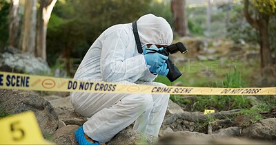 Forensic, photographer and police tape at crime scene for investigation in forest with evidence and safety hazmat. Csi quarantine, expert investigator and pictures for observation and case research