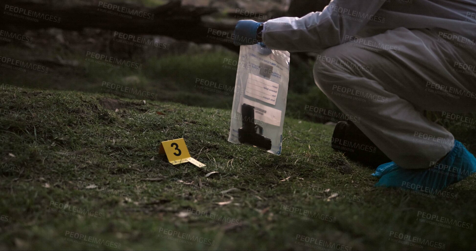Buy stock photo Crime scene, gun and investigator with evidence outdoor for forensics, analysis and investigation in forest or nature. Person hands with weapon, ppe and inspection or police search for clues in woods