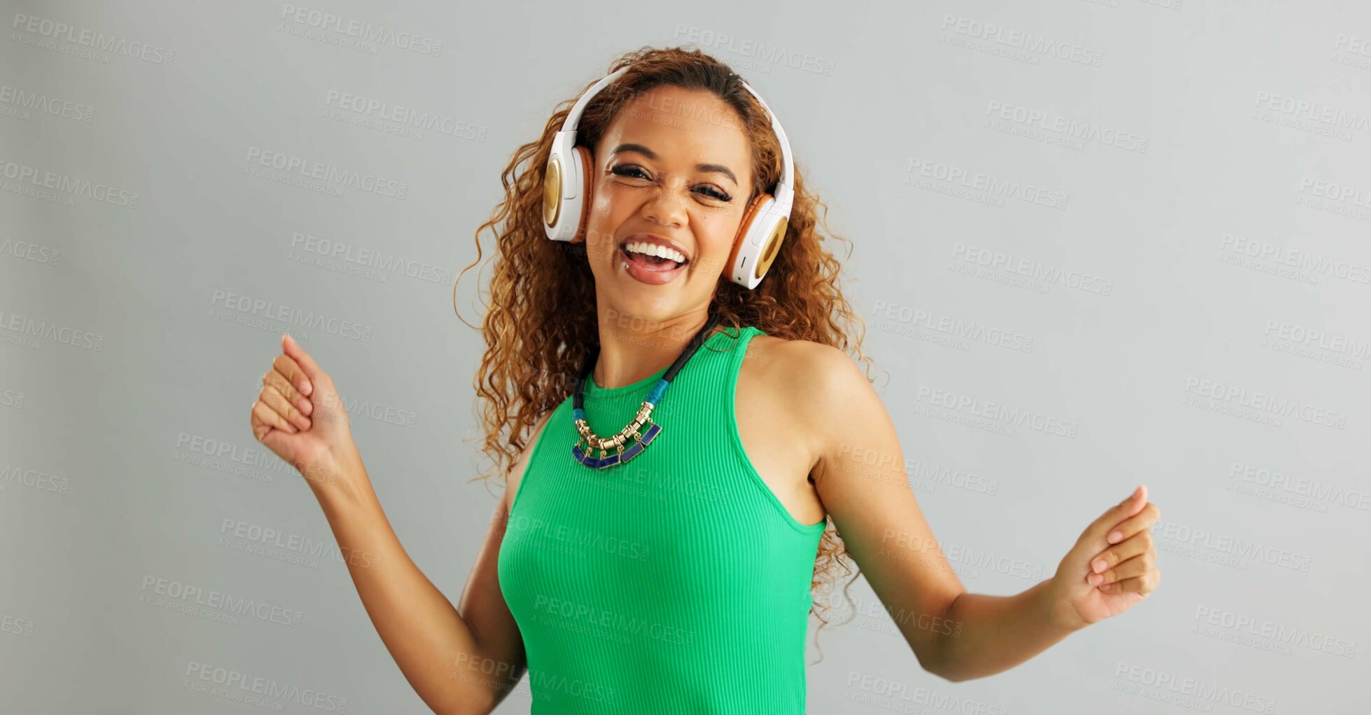 Buy stock photo Happy woman, dancing and listening with headphones to music or sound on a gray studio background. Excited female person or model enjoying audio podcast, energy or vibe with headset on mockup space