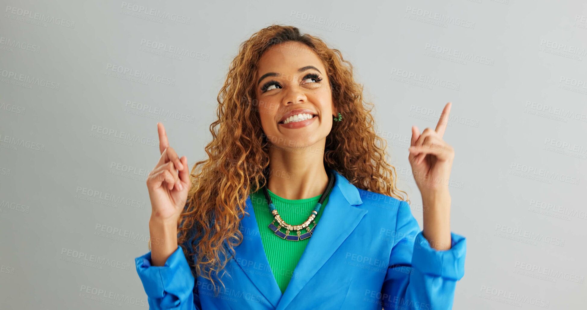 Buy stock photo Excited woman, advertising and pointing up with fashion for deal or sale on a gray studio background. Portrait of happy female person or model with smile for notification, alert or offer on mockup