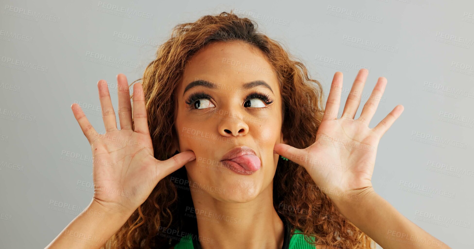 Buy stock photo Woman, funny face and studio with goofy comedy on grey background or humor mockup space, silly or joking. Female person, model and comic emoji expression with tongue out, peace sign or hand gesture