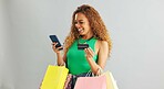 Happy woman, phone and credit card with shopping bags for payment on a gray studio background. Female person with smile or debit on mobile smartphone for online purchase, banking or app on mockup