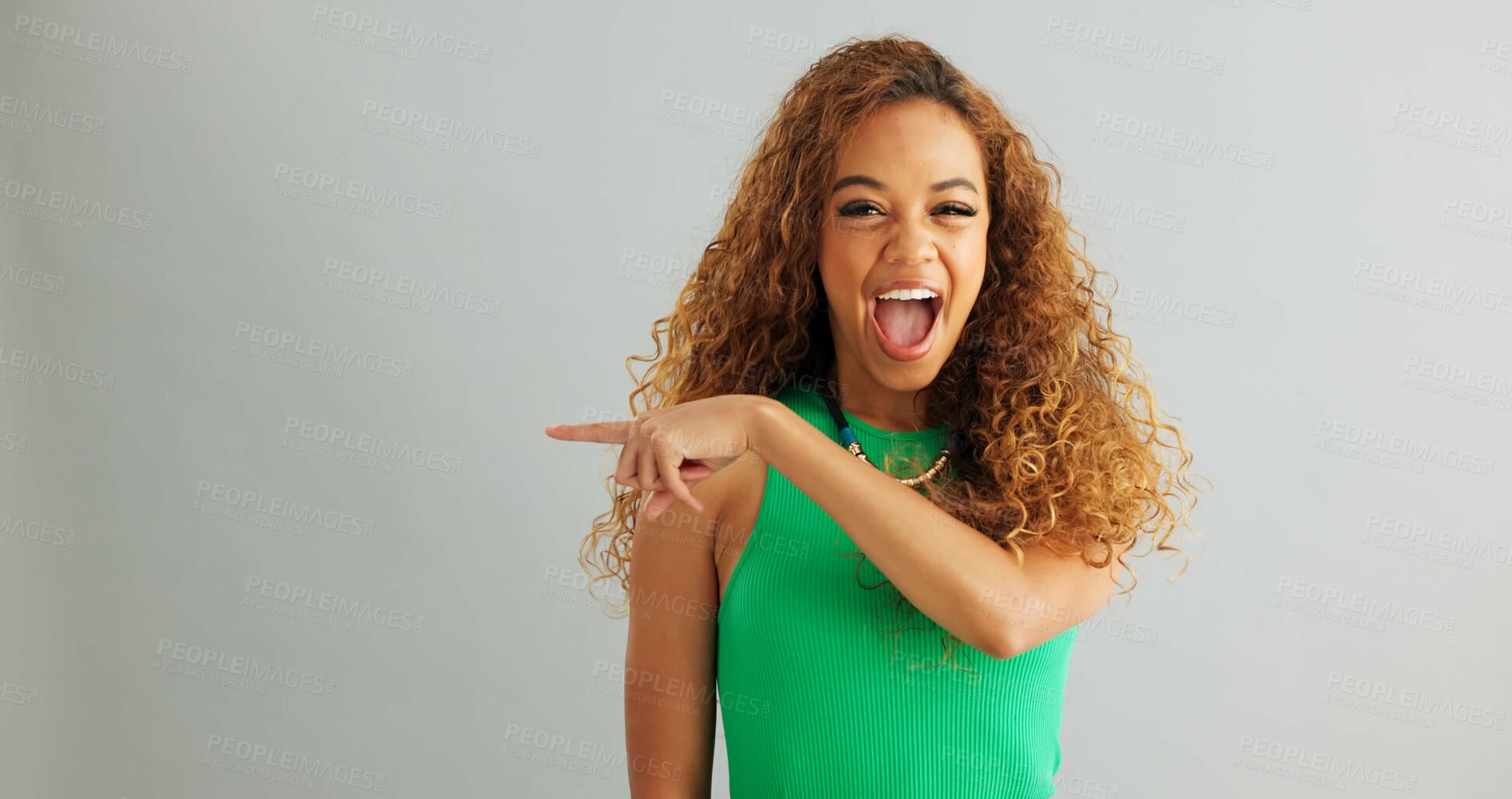 Buy stock photo Excited woman, pointing and advertising with mockup space for marketing on a gray studio background. Portrait of happy female person with smile for notification, alert or discount deal on promotion