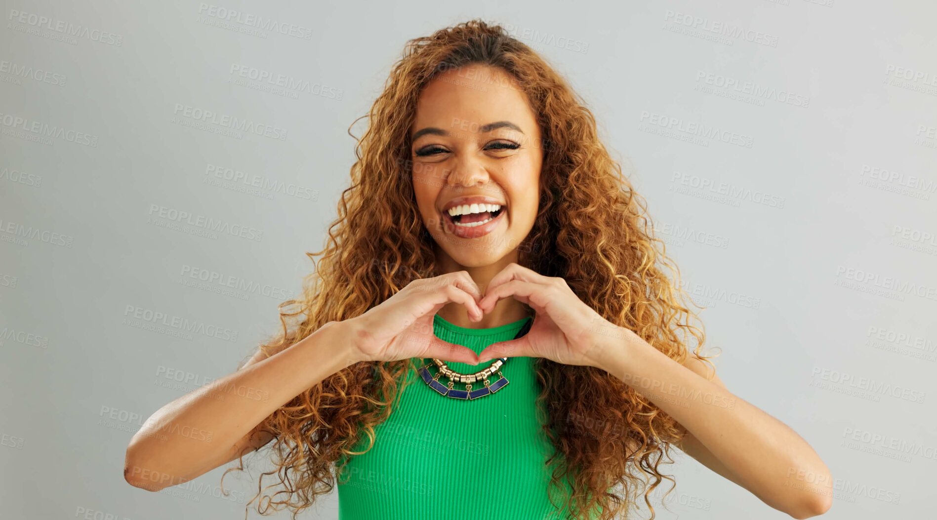 Buy stock photo Happy woman, love and care with heart hands for romance or trust on a gray studio background. Portrait of female person or model with smile, like emoji or shape for romantic gesture on mockup space
