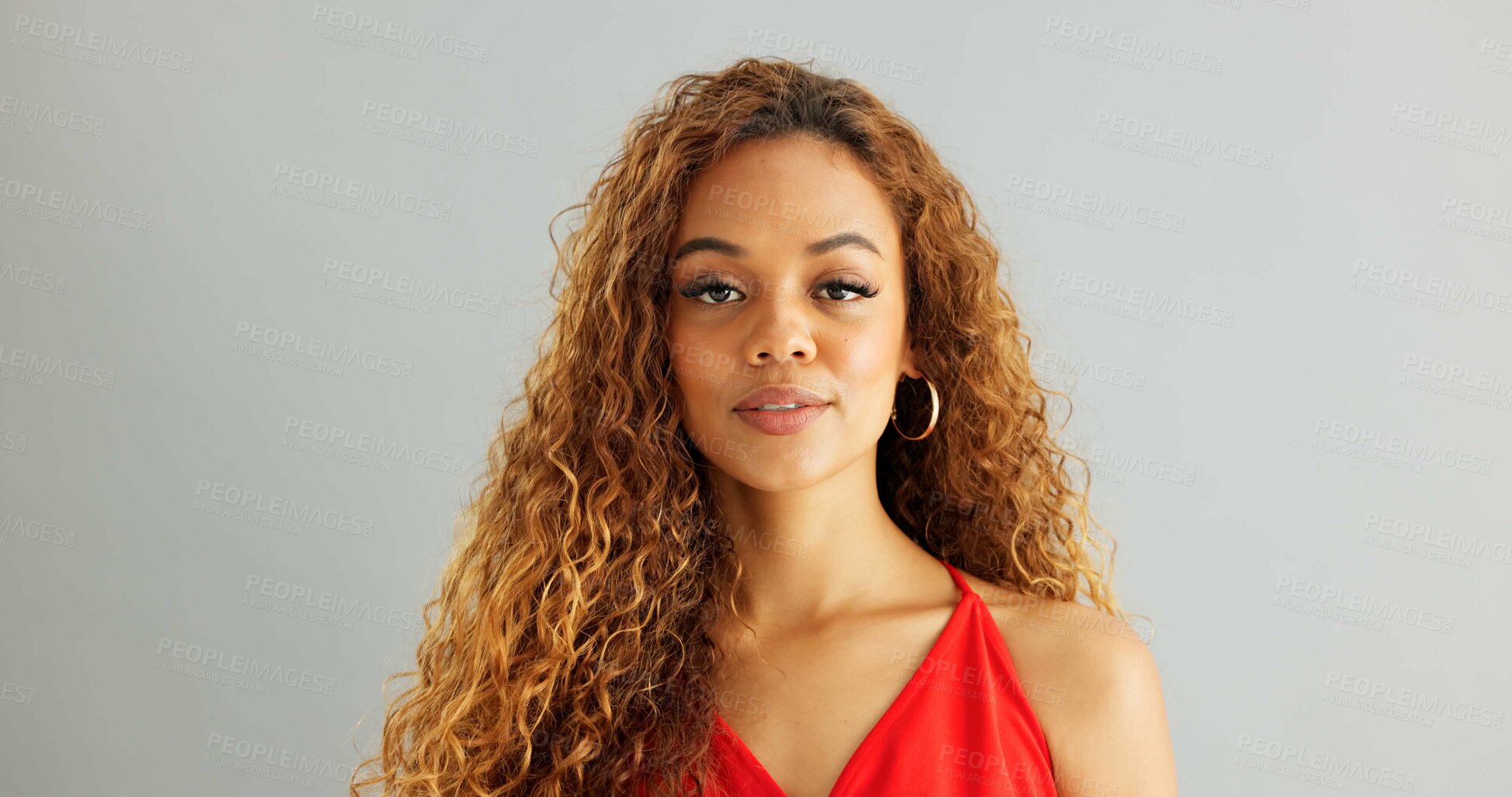 Buy stock photo Happy woman person, wink and laughing in studio, excited and flirt on grey background. Cheerful, joyful and smile on female model face, friendly and natural with curly hair of fun African Lady