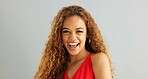 Happy woman person, wink and laughing in studio, excited and flirt on grey background. Cheerful, joyful and smile on female model face, friendly and natural with curly hair of fun African Lady