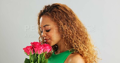 Happy woman, roses and valentines day with flowers for romance, love or care on a gray studio background. Portrait of female person with smile, bouquet and plant for romantic gift on mockup space