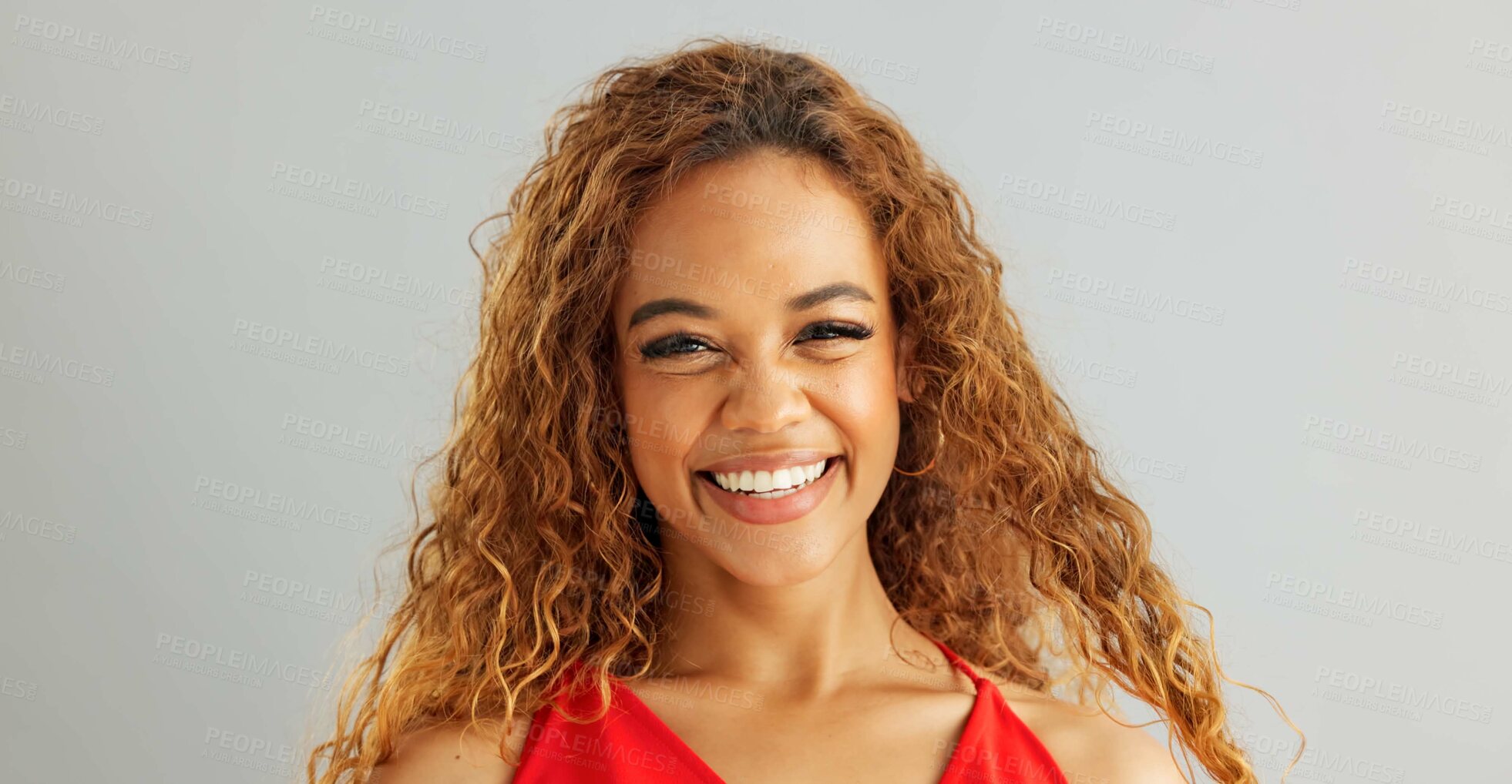 Buy stock photo Happy woman person, wink and laughing in studio, excited and flirt on grey background. Cheerful, joyful and smile on female model face, friendly and natural with curly hair of fun African Lady