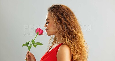 Young, woman and rose in studio with smile for gift, kindness and gratitude with scent or fragrance on a white background. Face of excited, African person or model with pink flower for valentines day