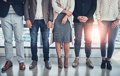 Buy stock photo Shot of a group of unrecognizable businesspeople standing in line in an office