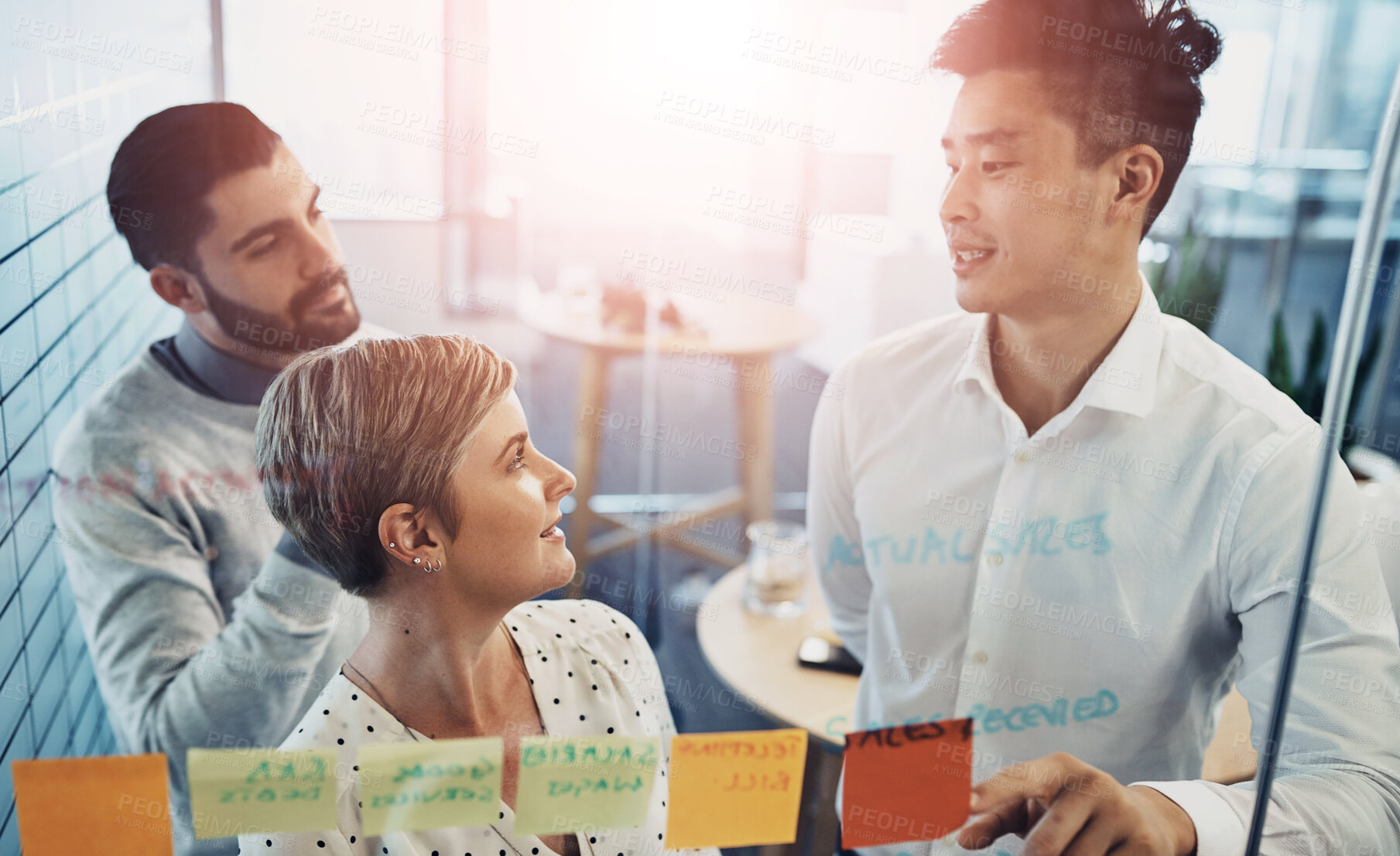 Buy stock photo Teamwork, brainstorming and business people with glass board, project ideas or sticky note in office. Lens flare, diversity and group of employees in meeting for planning, agenda or collaboration