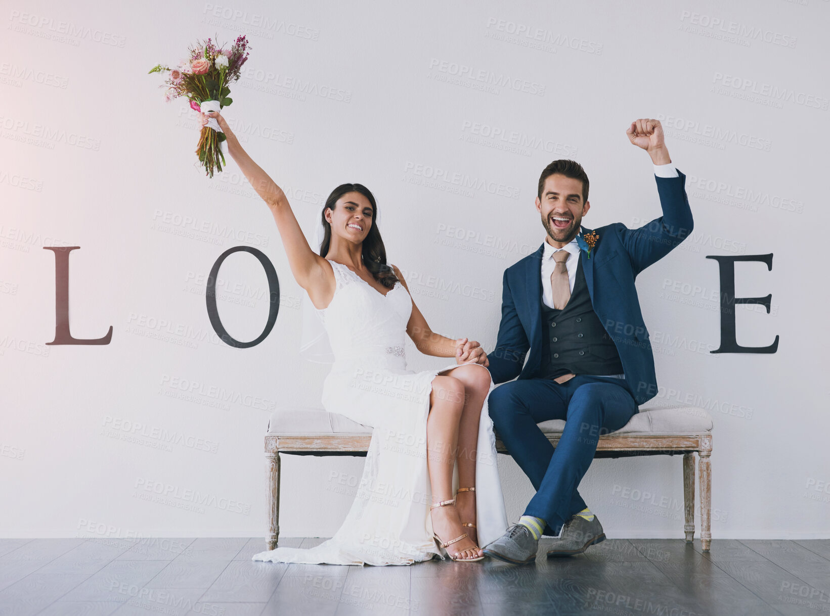 Buy stock photo Love, couple and holding hands in portrait at wedding with v shape for marriage, commitment and partnership on bench. Celebration, people and excited with bouquet for union, ceremony and romance